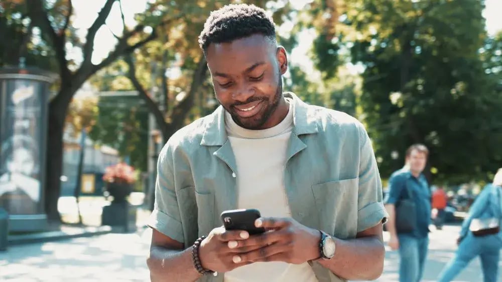 man using phone outside to buy tickets | payments process