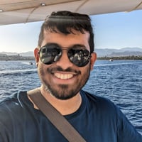 Shaikhul on a boat, wearing sunglasses